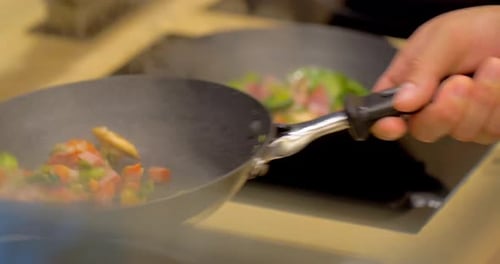 Professional chef expertly preparing delicious omelet in restaurant kitchen