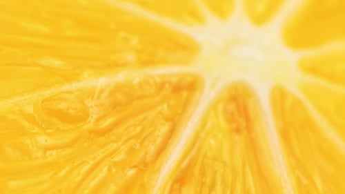 A close up of a yellow orange slice