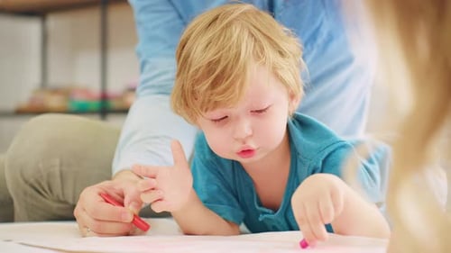 Blond Haired Boy Drawing with Crayons