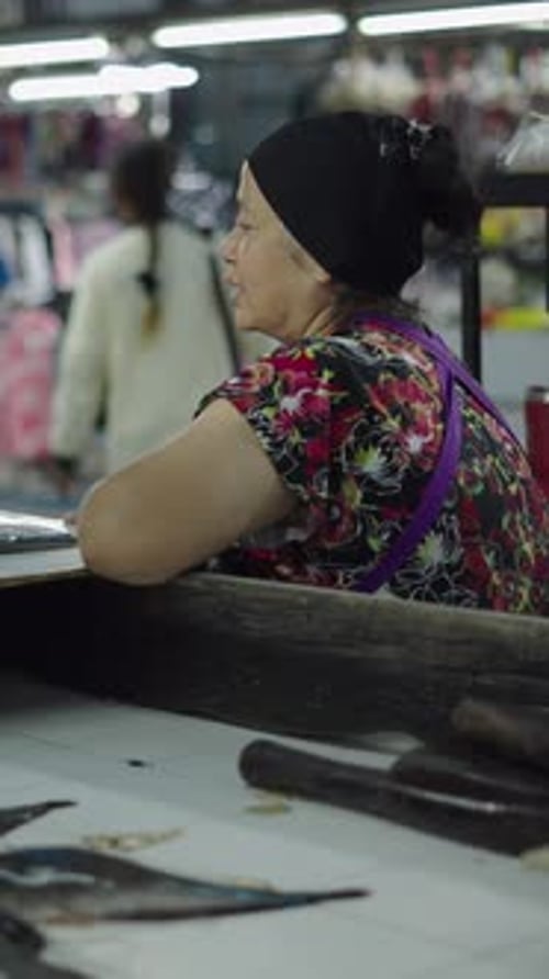 Asian Lady in a Local Market Looking at Camera While Waiting to Be Served in the Weighing Shop