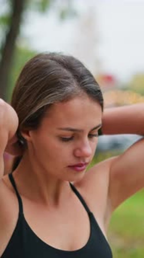 Young Lady Packing Her Hair in Game Park Preparing for Outdoor Activity