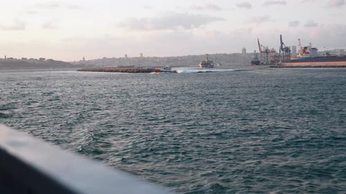Boats Sailing on Water near City Skyline