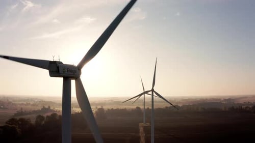 Aerial View of Wind Turbines in the Rising Sun Turbines in a Rural Area