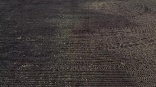 Flight Over a Plowed Field of Black Soil on a Sunny Day A Dug Up Field of Earth