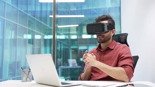 Man Using VR Headset at Desk in Office