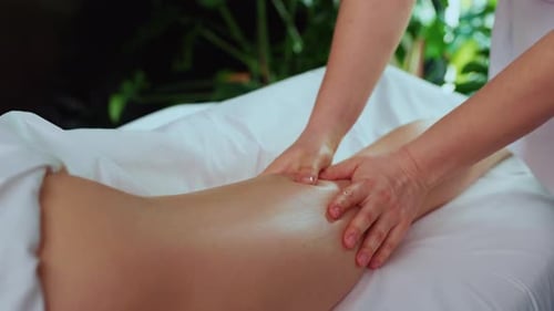 Therapist Giving Leg Massage in Relaxing Indoor Setting
