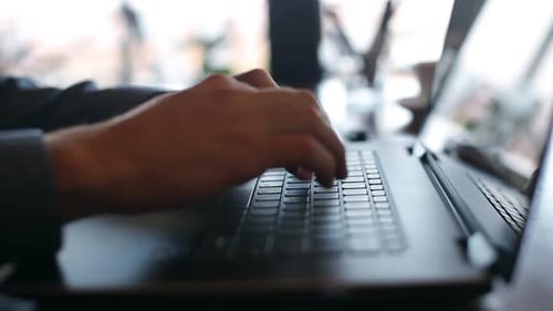 Camera Slides Around Freelancer's Hands Typing on Laptop Keyboard in Cafe Businessman Working at