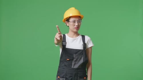 Asian Woman Worker Wearing Safety Helmet Disapproving With No Index Finger In The Green Screen