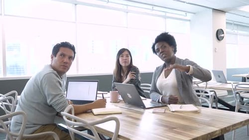 Business team strategizing together around a table in a modern coworking office