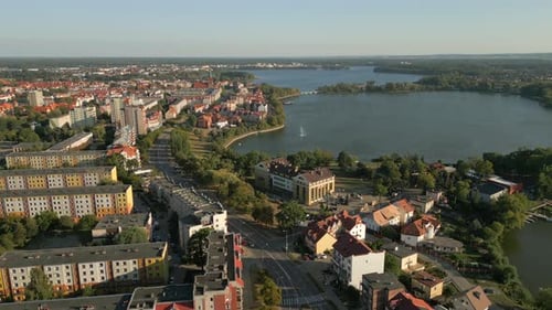 Panoramic view of Elk cityscape on the shore of Ełk Lake surrounded by deep forest, Aerial