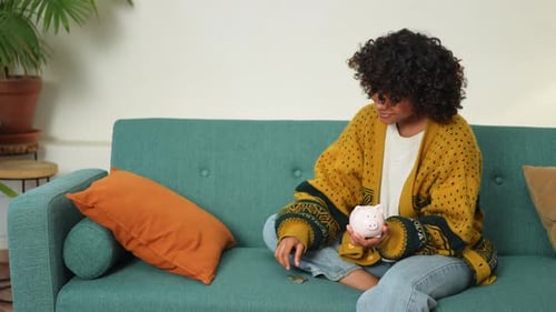 Saving Money Investment for Future African American Girl Holding Pink Piggy Bank and Putting Money