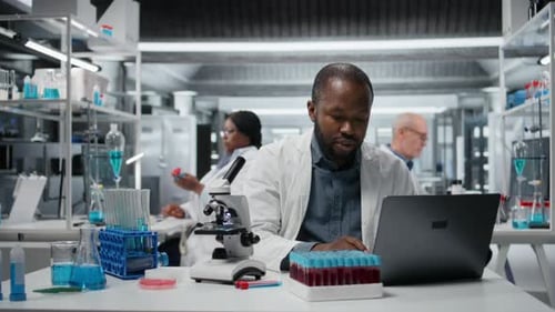 Scientist analyzing blood sample in modern laboratory