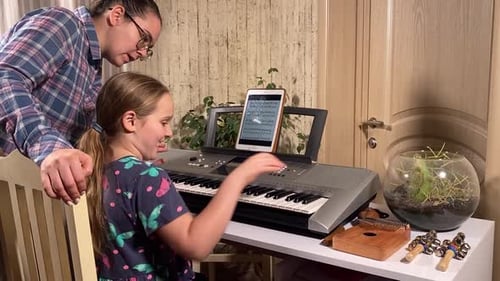 Girl Learns Piano with Tutor at Home