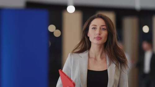 Young Attractive Caucasian Businesswoman with Beautiful Face Walking on Business Center Corridor