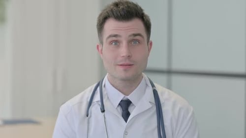 Portrait of Young Doctor Shaking Head in Approval