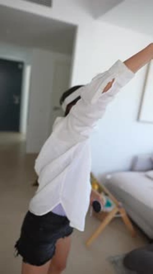 Woman Experiencing Virtual Reality Game Indoors