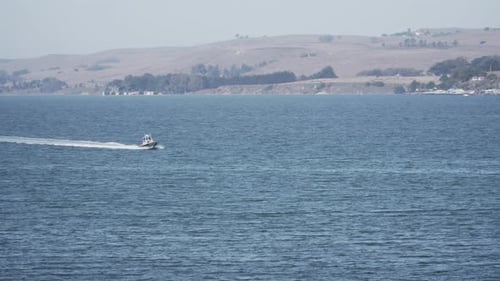 Small Boat Moving Quickly Through the Waters of the River Bay
