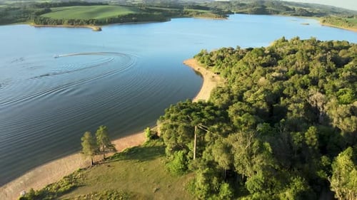 Orbital drone view at a lake with summer leisure activities.