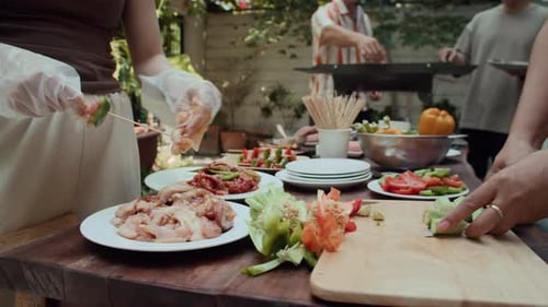 Friends Preparing Food for an Outdoor Barbecue