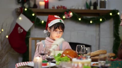 Child Opening Magical Christmas Gift With Family