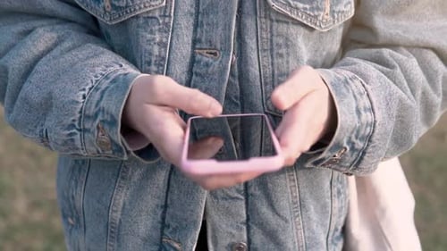 Close up of woman hands touching a phone screen for chat and check social media