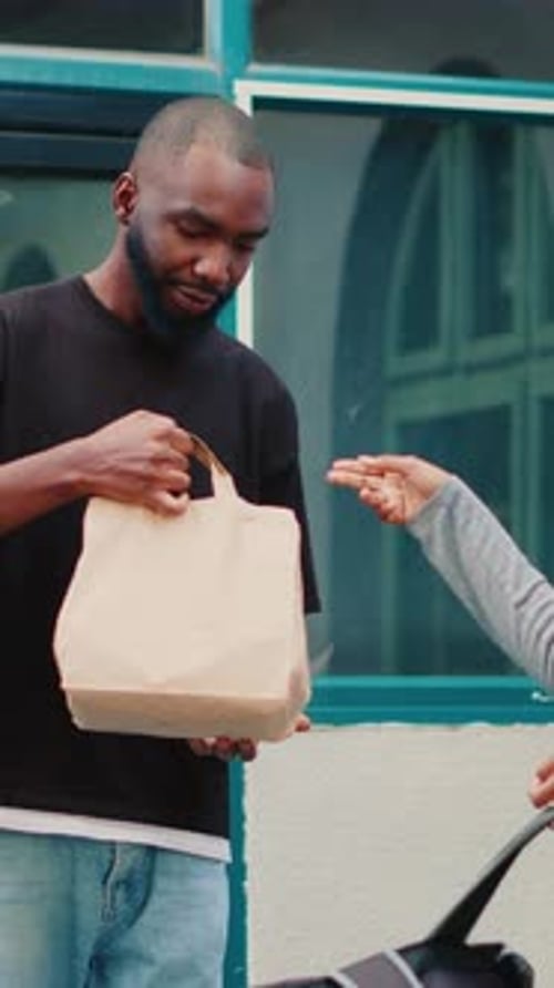 Vertical Video African American Courier Delivering Restaurant Meal to Wrong Client