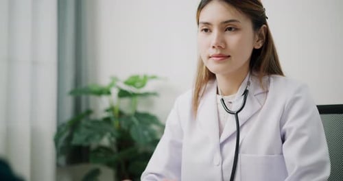 Female Doctor Consulting Patient in Clinic Setting