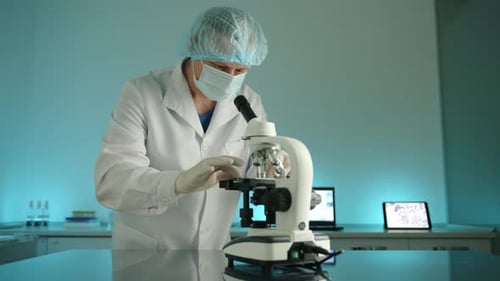 Medical Scientist Prepares Microscope Slide for Analysis