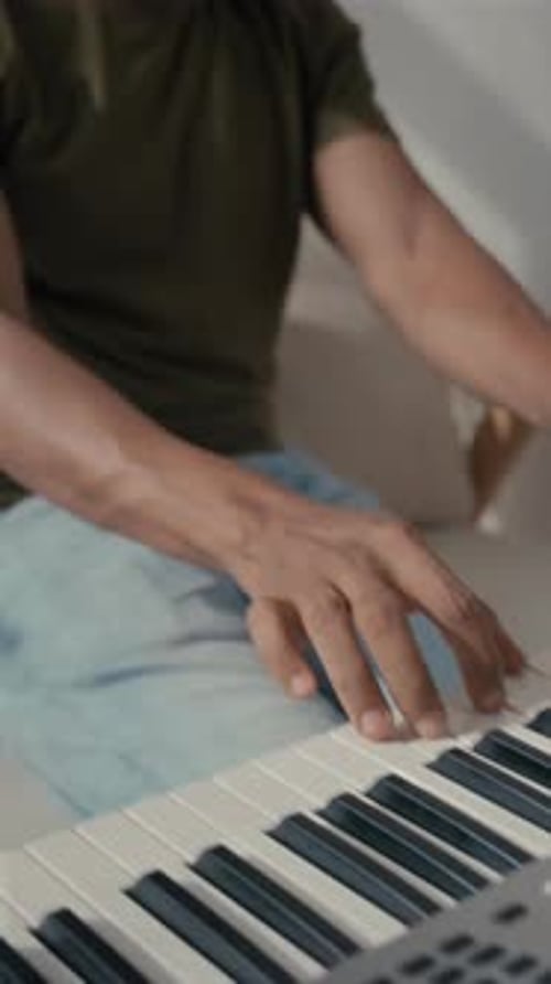 Man Plays Digital Piano Wearing Headphones