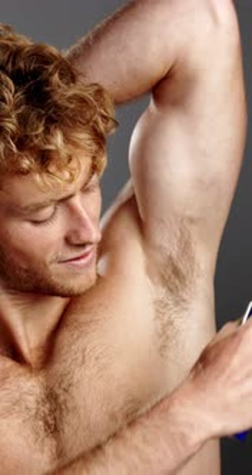 Deodorant, smile and spray with shirtless man in studio for fresh aroma, grooming or hygiene