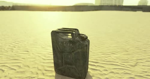 Desert Landscape with an Old Fuel Canister Under Warm Sunlight