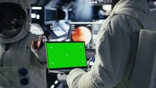 Astronauts Reviewing Onboard Analytics on Isolated Screen Tablet