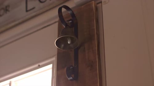 Wooden door closing with bell.