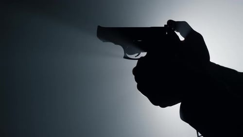 Silhouette of Man Hand Holding Gun Indoors. Closeup Unknown Criminal Arm Cocking