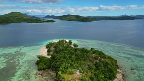 Small tropical island surrounded by distant islands