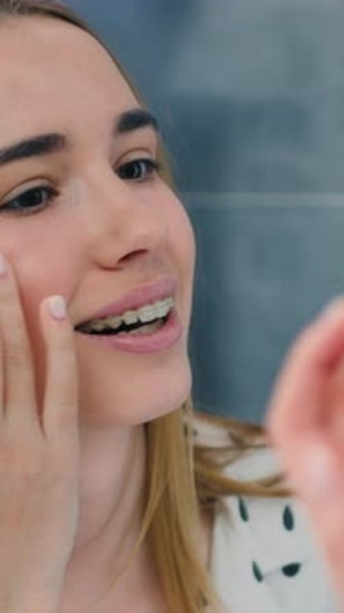 Teen Girl Smiling and Touching Her Face