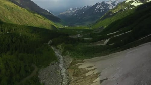 Majestic River in Valley with Mountains and Trees