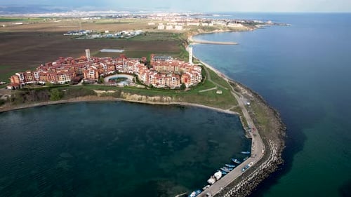 Aerial view of marina and lighthouse along coastline, Bulgaria.
