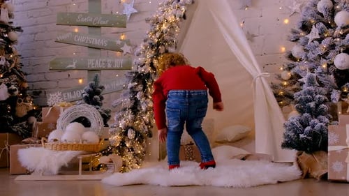 Child Jumps on Rug Amidst Christmas Decorations