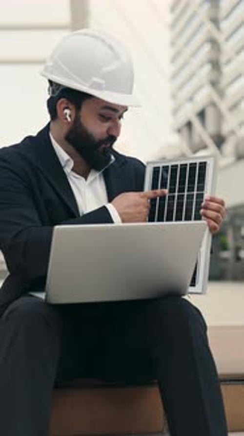 Bearded Indian Engineer in Helmet Demonstrating Solar Panel on Video Call