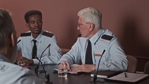 Three Men Discussing Business at Conference Table