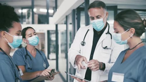 Healthcare Team Discussing Patient Data in Hospital