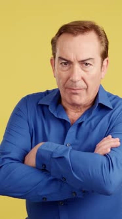 Mature Man Crossing the Arms with an Angry Expression