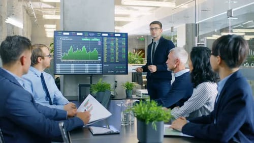 Stock Trader Gives Presentation to Executive Managers, Showing His Prognosis of the Trade Market Be