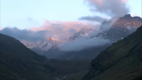 Cloudy morning light show an Austria mountain panorama with curvy roads near Ischgl from a drone aer