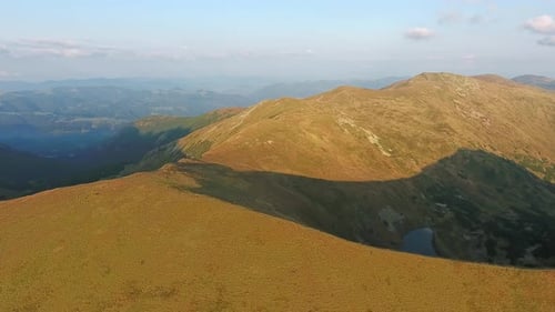 Aerial View of Mountain Ridge Flight Over Summit in Sunny Summer Day