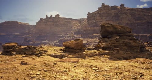 Rugged Desert Landscape with Towering Rock Formations and Clear Sky