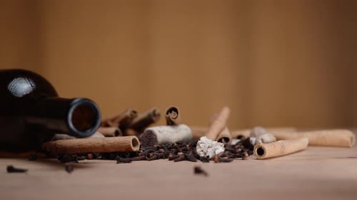 Bottle and Spices on Wooden Table