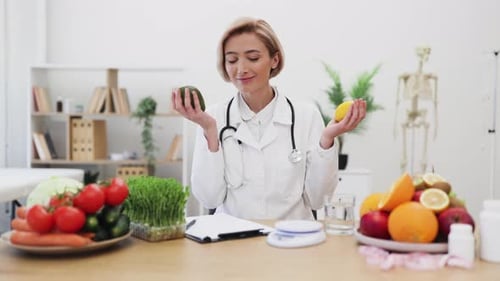 Smiling Dietitian with Avocado and Lemon Promoting Healthy Eating