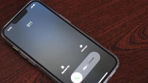 Declining 911 Call on Smartphone on Wood Table